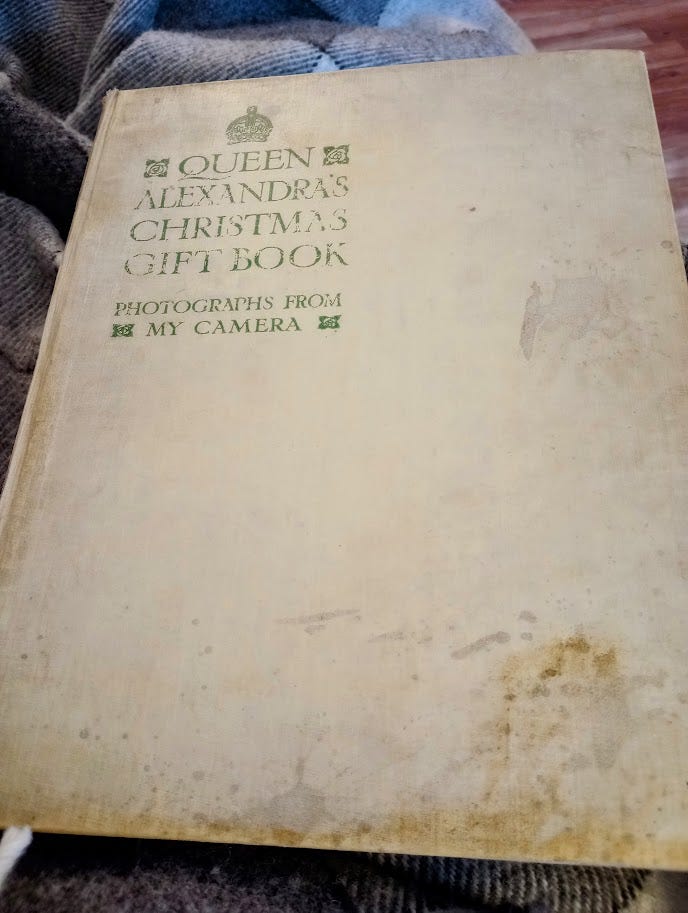 Faded cover of large hardback book titled Queen Alexandra's Christmas Gift Book: Photographs from My Camera"