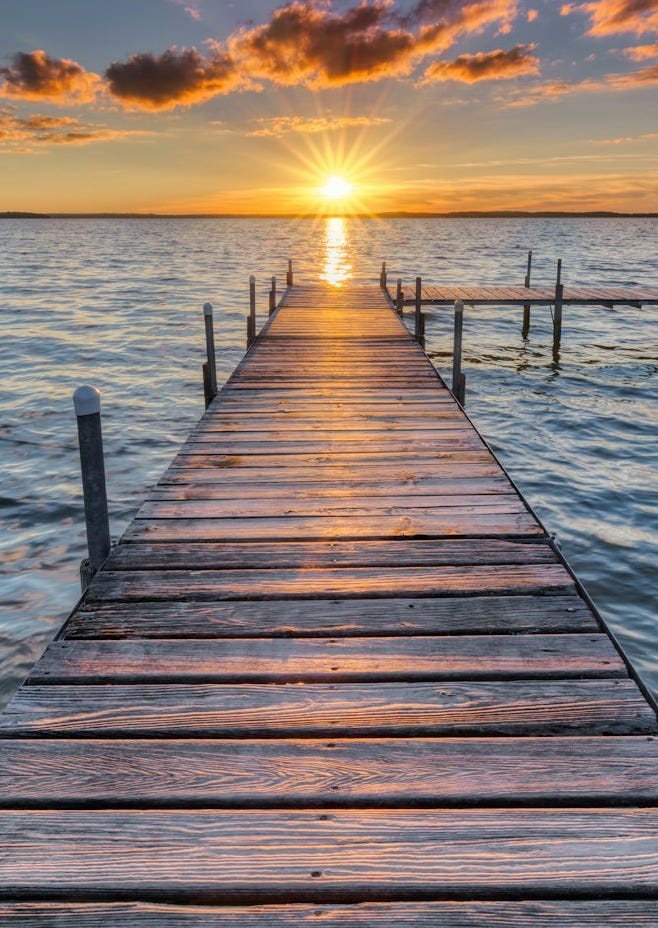 brown wooden dock on sea during sunset brown wooden dock on sea during sunset