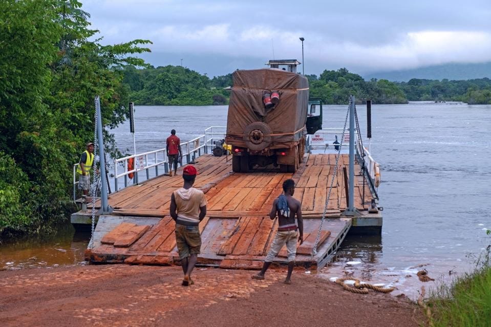 Truck on ferry boat crossing the Essequibo river in the rainy season along the Linden-Lethem dirt road.