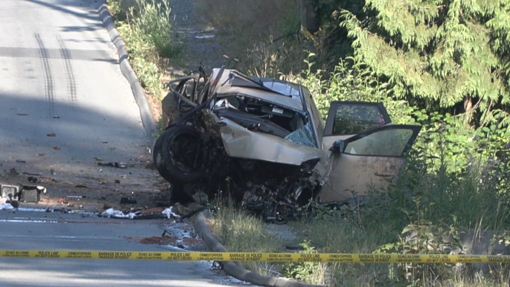 A tan-coloured Hyundai Santa Cruz with significant damage remained on the side of the road with what appeared to be a body under a tarp lying next to it. (CTV News)