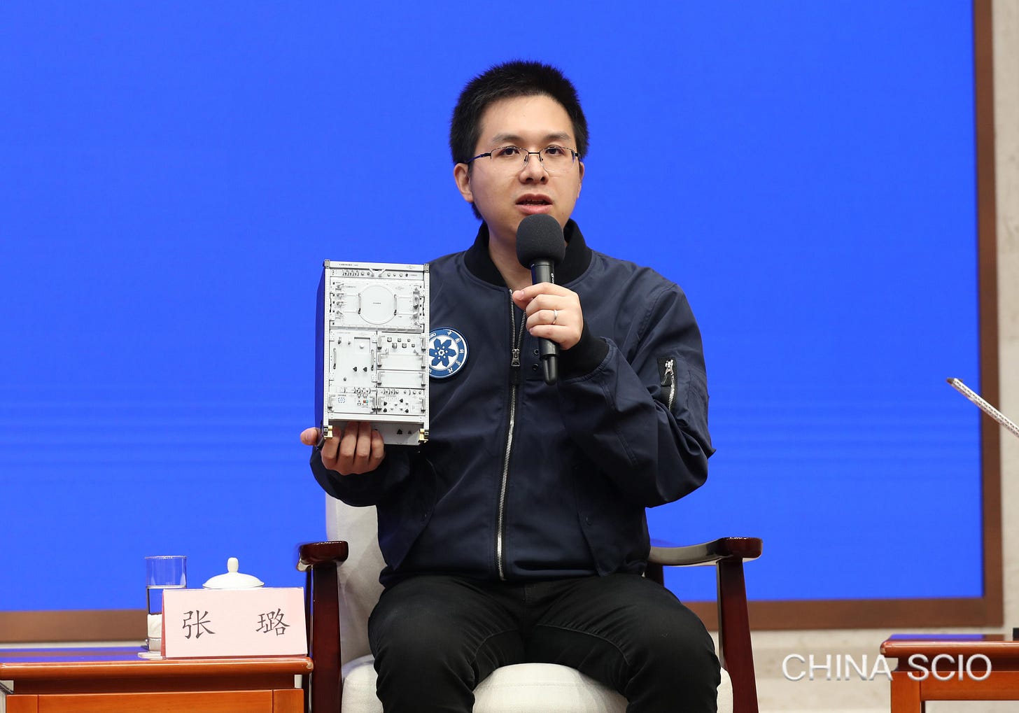 Zhang Lu speaks at the press conference while holding a model of an experiment rack onboard the Tiangong Space Station. Zhang Lu speaks at the press conference while holding a model of an experiment rack onboard the Tiangong Space Station.