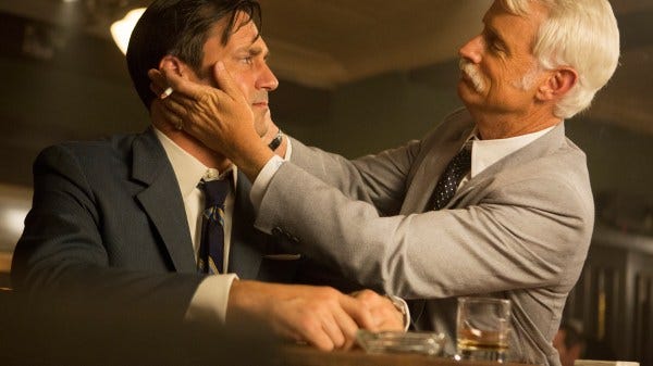 Don Draper (Jon Hamm) being embraced by his mentor Roger Sterling (John Slatterly) in Mad Men