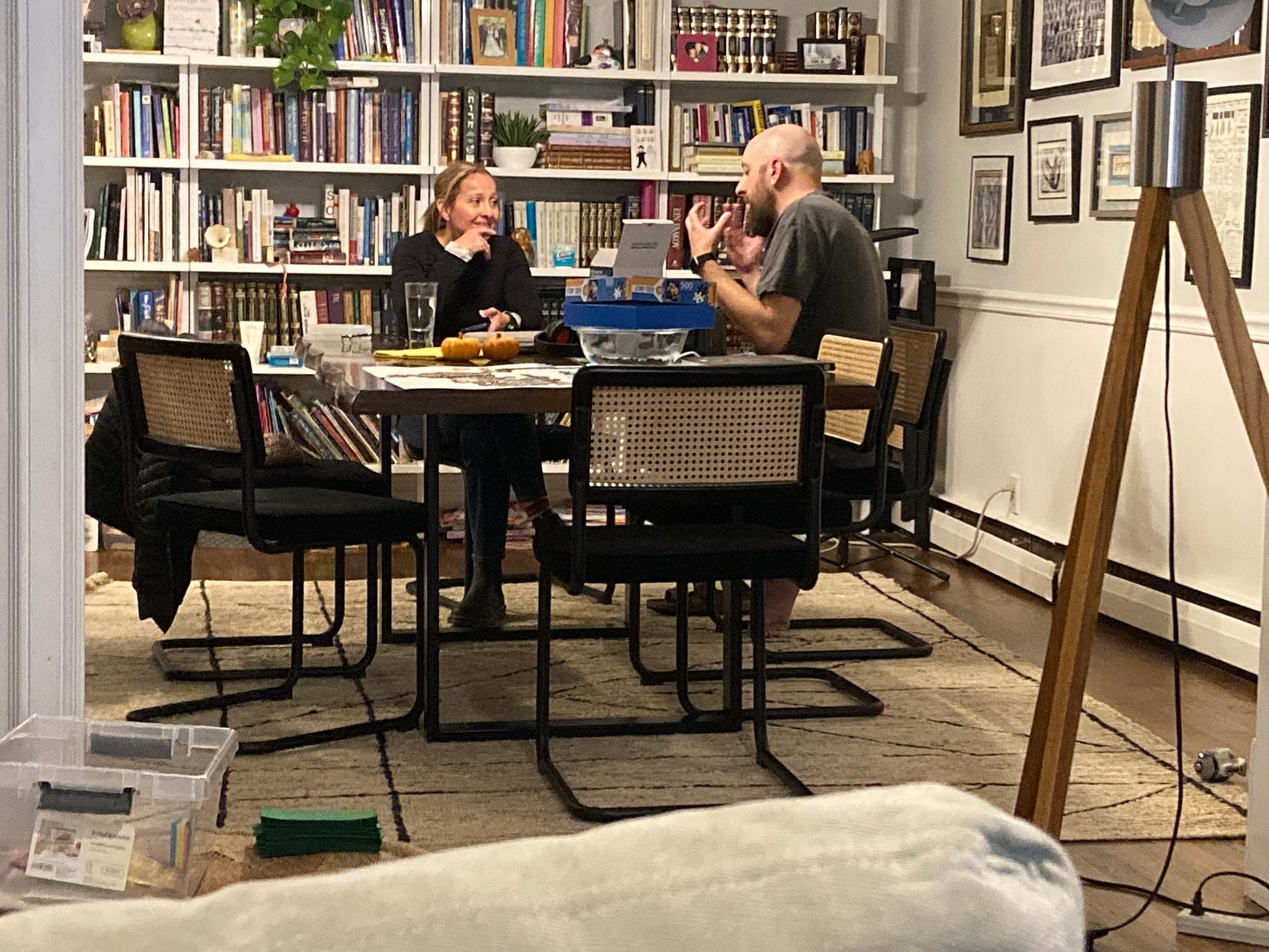 photo of Erin and Henry sitting at a table as Erin interviews him