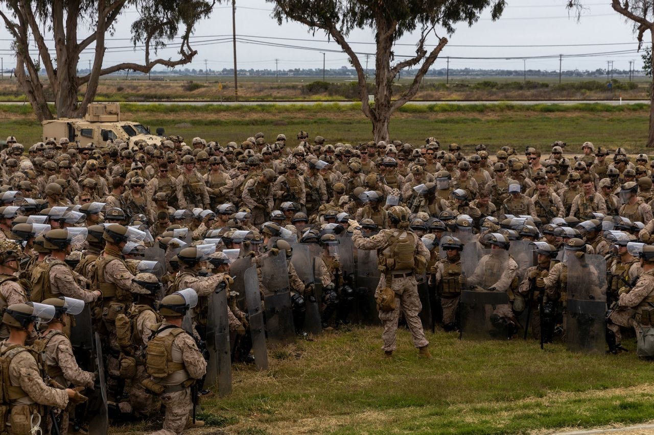 US Marines are briefed by battalion leadership while rehearsing crowd control tactics at a base in the Los Angeles area, on Tuesday.