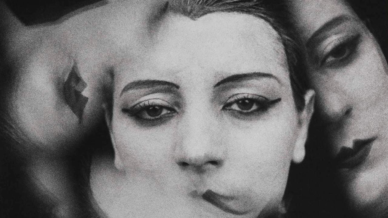 Movie still from Ballet Mecanique. A black and white overlay of a woman's face with makeup, repeated three times.