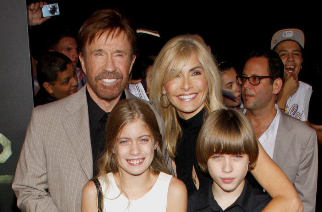 Chuck Norris with his wife and kids at a red carpet event.