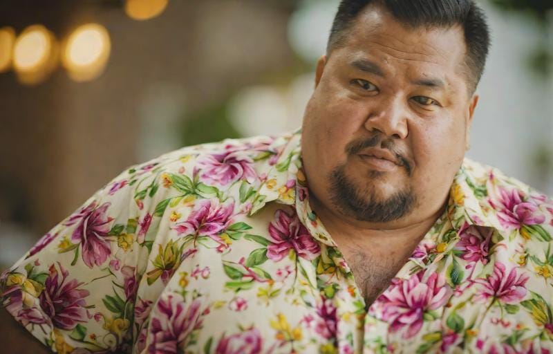 Heavy man in flowery shirt with goatee
