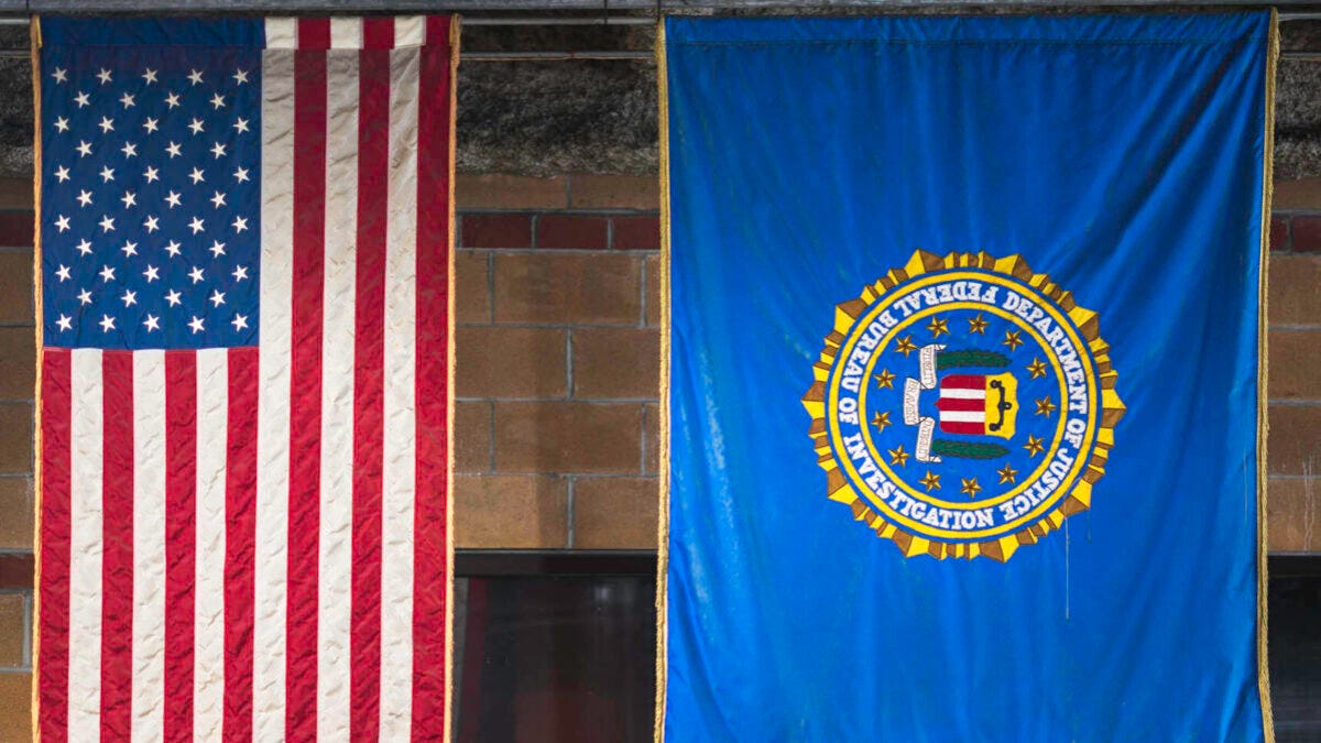 U.S. flag next to DOJ/FBI flag
