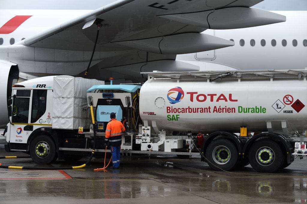Staff members refuel an Airbus A350-900, the first Air France jet long-haul aircraft fuelled with sustainable aviation fuel produced by French energy group Total at Roissy airport on May 18, 2021.  (ERIC PIERMONT/AFP—Getty Images)