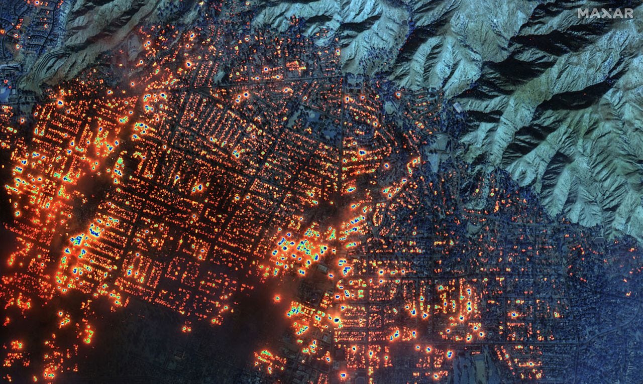 A satellite image shows the Eaton wildfire has set nearly every building in western Altadena on fire.