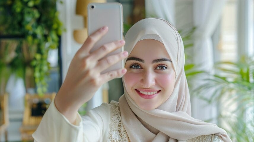 Happy young muslim woman take self portrait