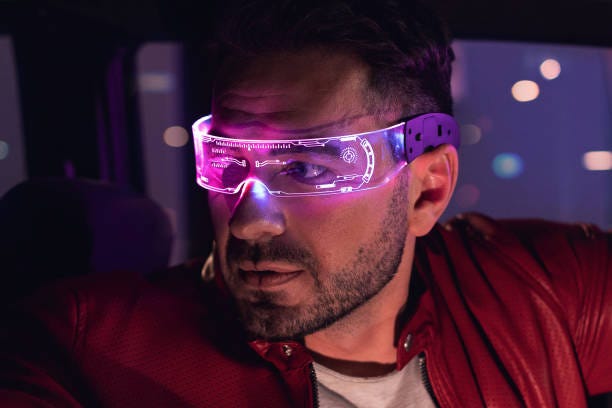 Male portrait of one man indoors the car. Neon light concept photography, futuristic photo with red color lighting indoors the vehicle. Person wear glowing eyeglasses and driving vehicle Male portrait of one man indoors the car. Neon light concept photography, futuristic photo with red color lighting indoors the vehicle. Person wears glowing eyeglasses and driving a vehicle virtual reality stock pictures, royalty-free photos & images