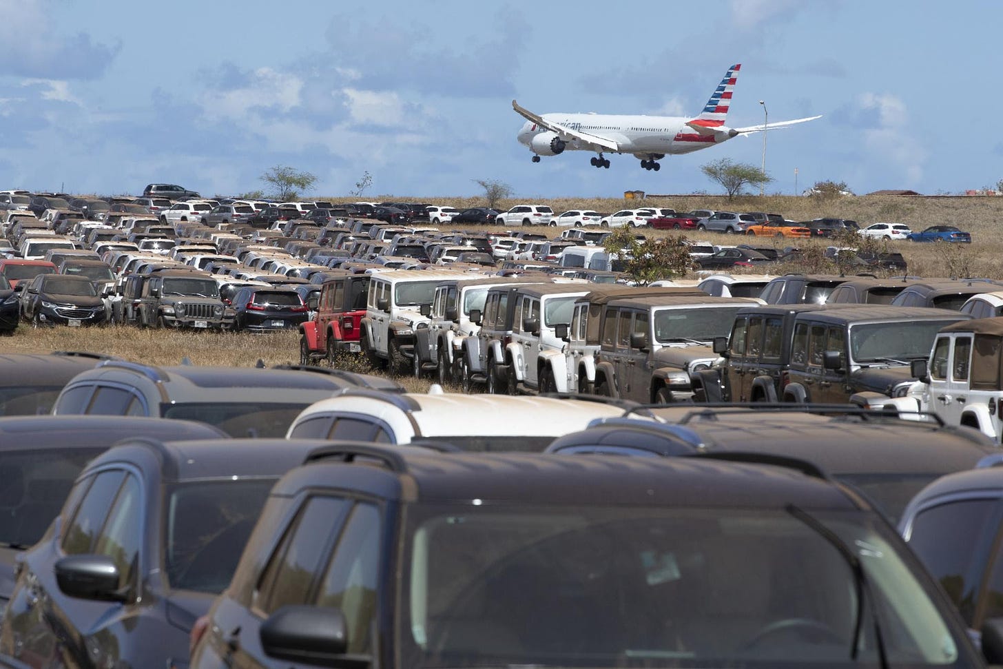 Unused rental cars are parked in an overflow lot at Kahului Airport, Hawaii. 