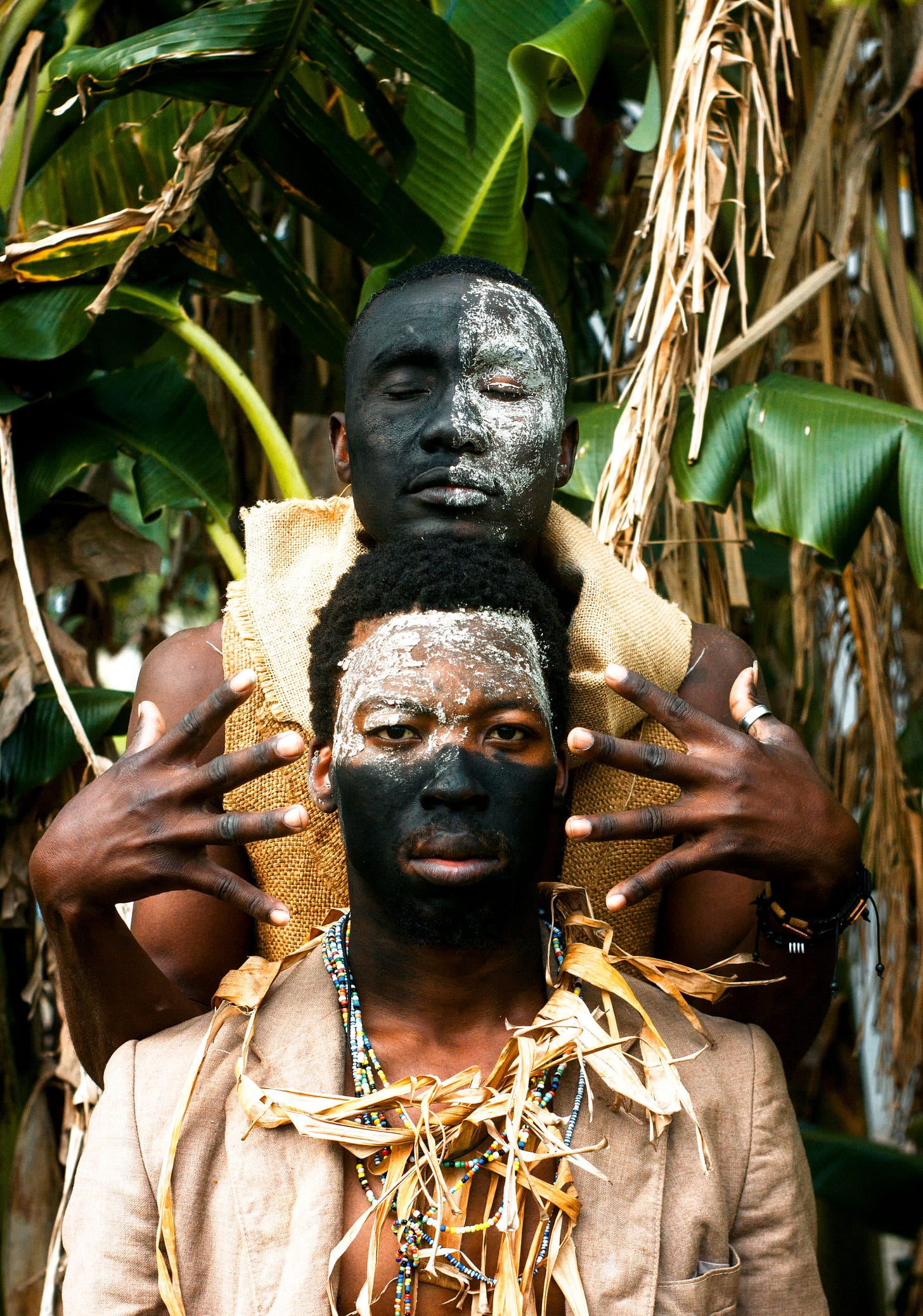 two men with black and white face painting 