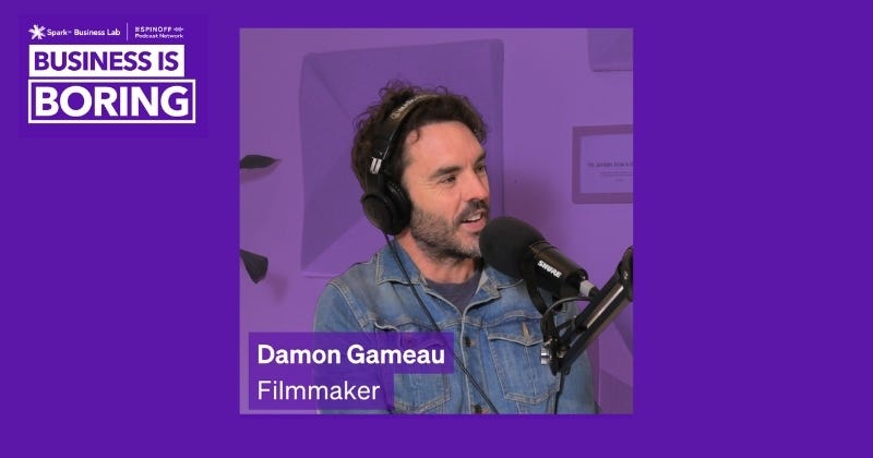 The text "BUSINESS IS BORING" is prominently displayed in the top left corner, indicating the name of the podcast. The guest on the show is identified as "Damon Gameau," a filmmaker, as noted by the text in the lower left corner. Damon Gameau is shown speaking into a microphone, likely during a recording of the podcast.