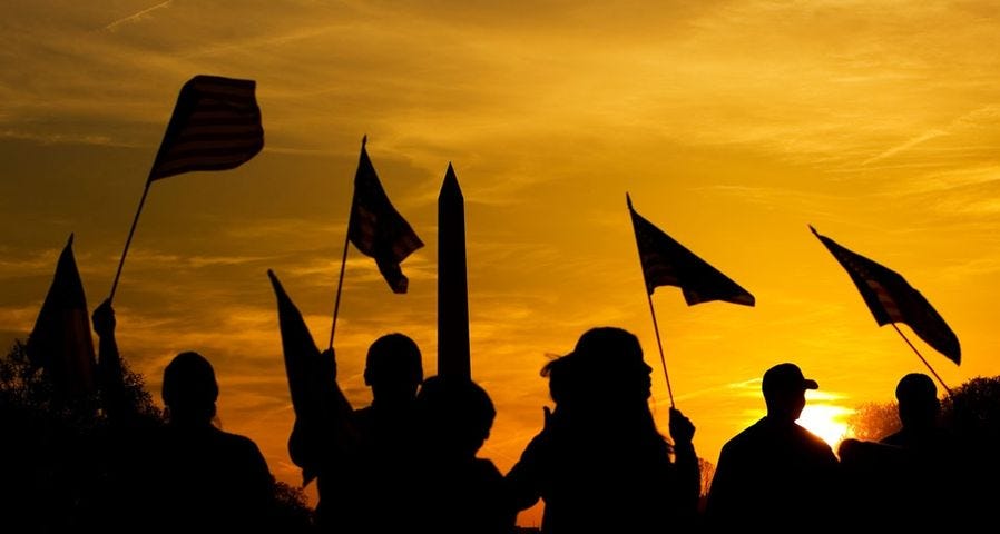 People holding American flags at sunset near the Washington Monument in  Washington, D.C. - Bing Gallery