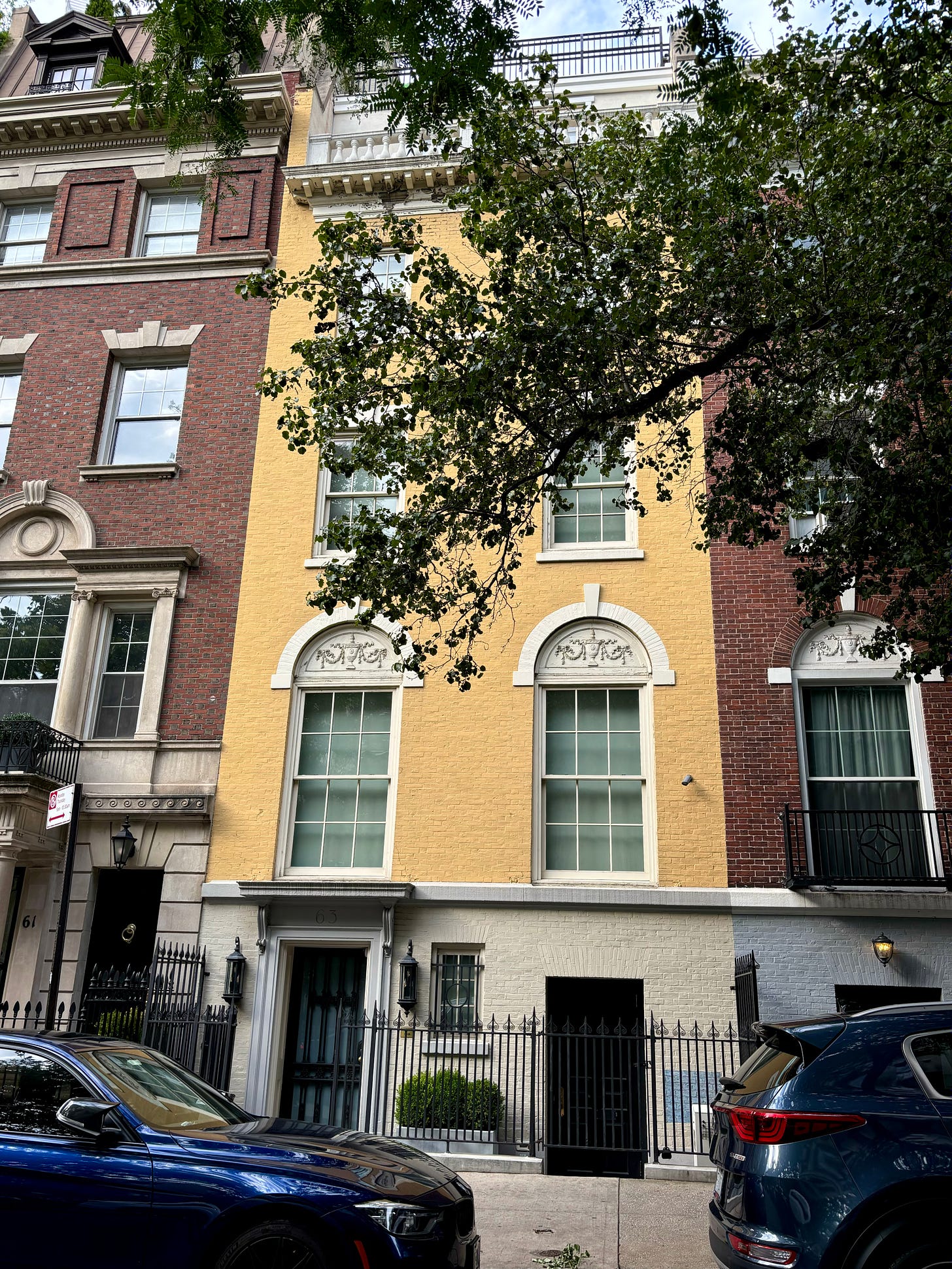 A pretty yellow townhouse, slender and elegant, on a treelined sidewalk between two stately, red brick homes. (Technically, one is a Scientology center now but I don't think they were Hellman's neighbors.