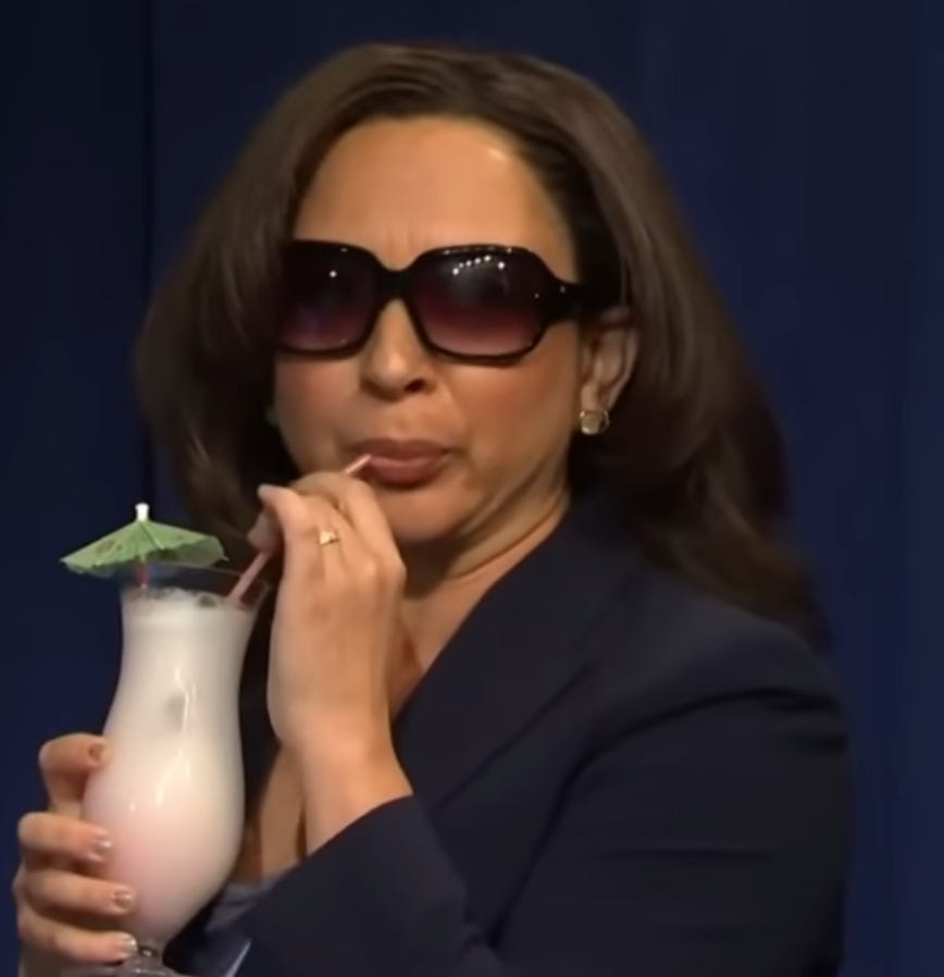 An image of Maya Rudolph as Kamala Harris in a Saturday Night Live sketch; she is wearing sunglasses and sipping a tropical drink from a straw