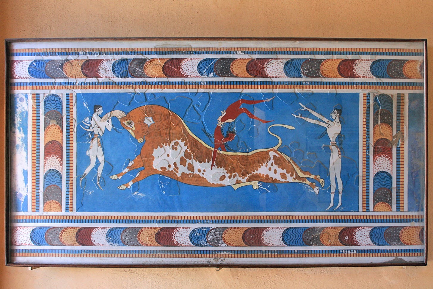 Picture of men leaping over a charging bull depicted on a wall painting from Crete.