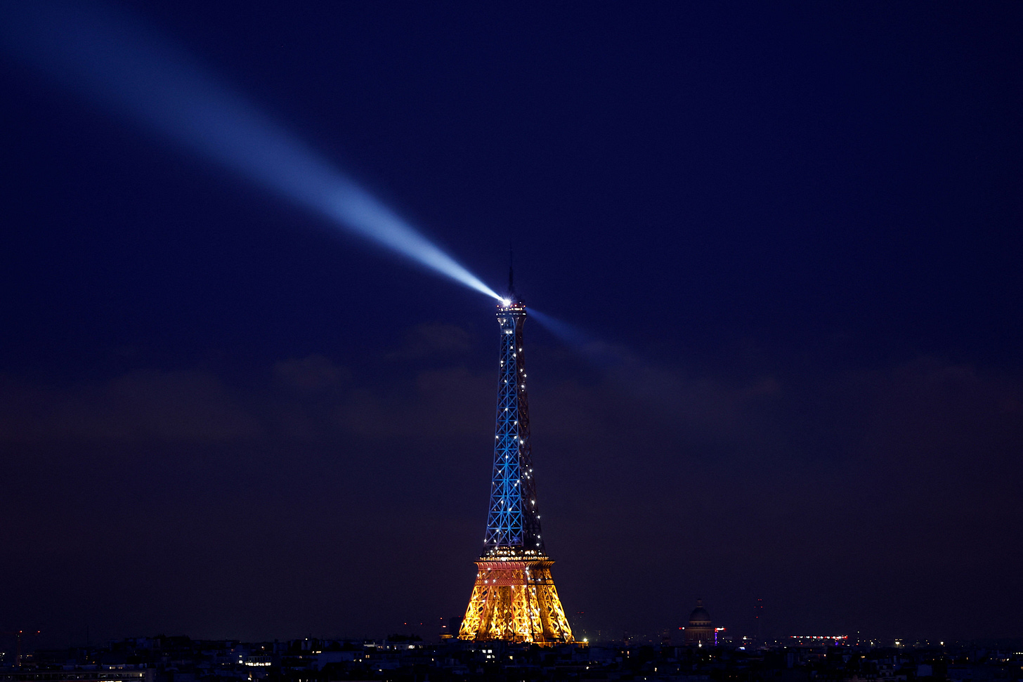 The Eiffel Tower is lit up in blue and yellow, the national colours of Ukraine, to mark the third anniversary of Russia's invasion of Ukraine, in Paris, France, February 24, 2025. REUTERS/Abdul Saboor