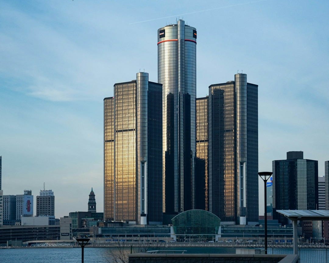 a very tall building sitting next to a body of water