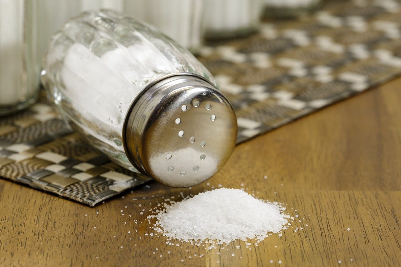 salt shaker, turned over with spilled table salt