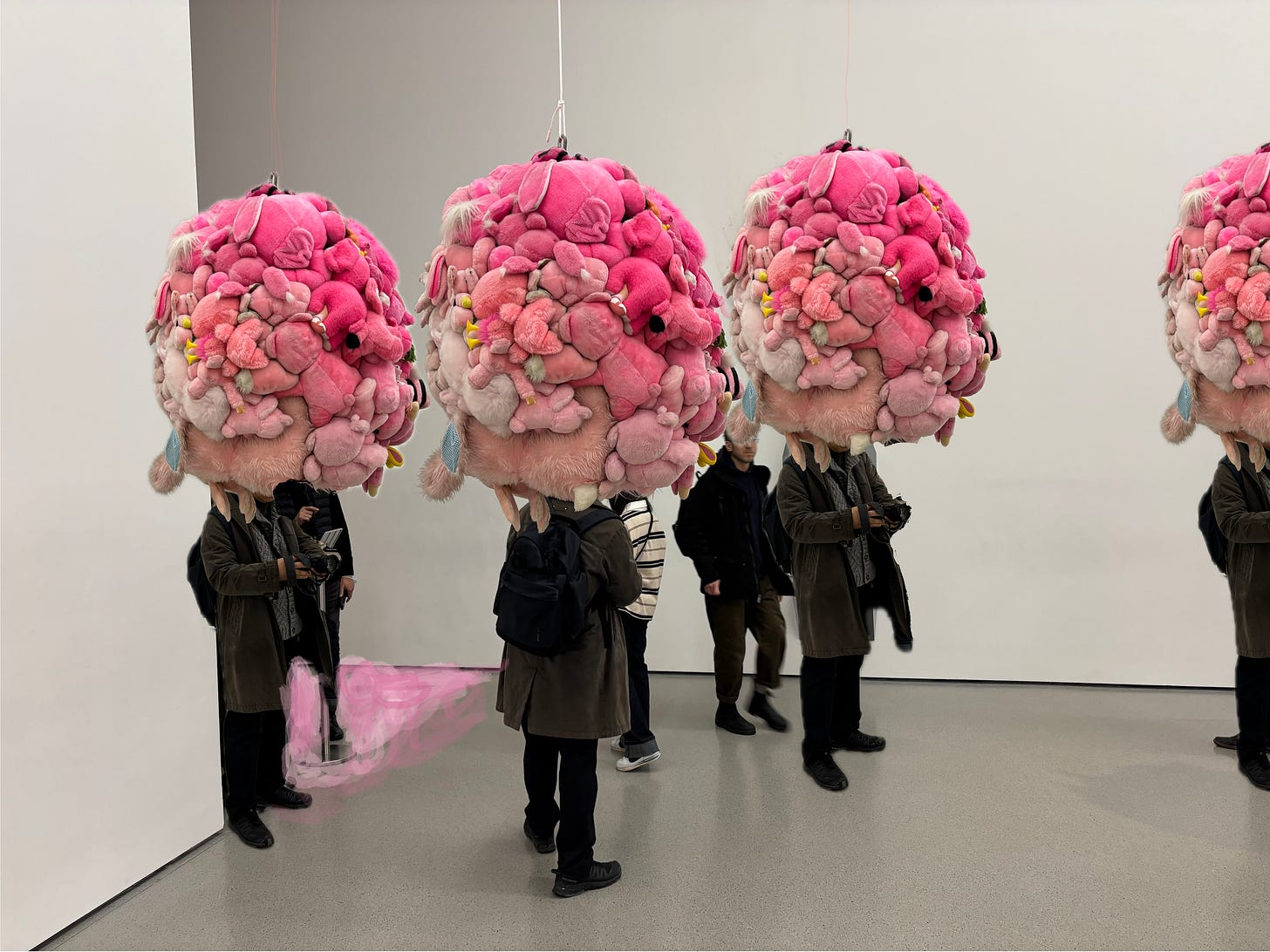 men with balls of stuffed toys on their heads