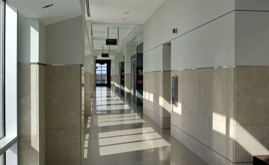 photo of a hallway made of marble and windows