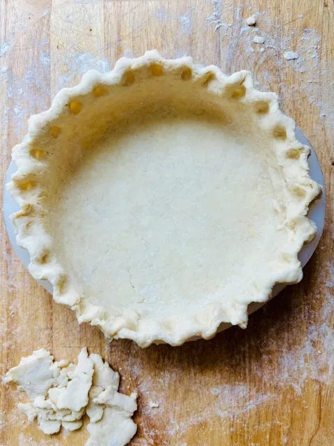 Pie dough pressed into a pie plate and ready to bake.