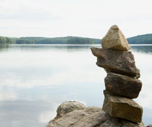 A Carin, or stacked rocks, with water in the background.