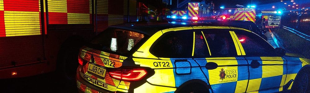 Essex Police car, fire engine and numerous emergency vehicles at night