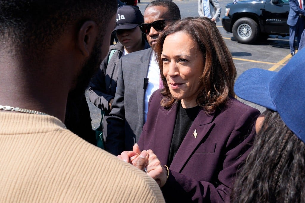 Vice President Kamala Harris in a purple suit, greeting supporters at Soldier Field, Chicago, before boarding Marine Two, post-2024 Democratic National Convention