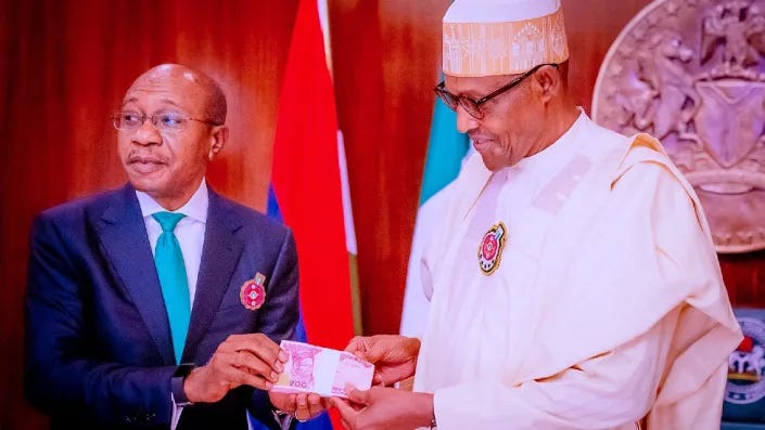 CBN's Godwin Emefiele (L) unveils the designs of new banknotes with Nigerian President Muhammadu Buhari (R) on 23 November 2022 in Abuja, Nigeria