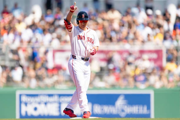 Masataka Yoshida of the Boston Red Sox reacts after hitting a ground-rule double during the first inning of a Grapefruit League game against the New...