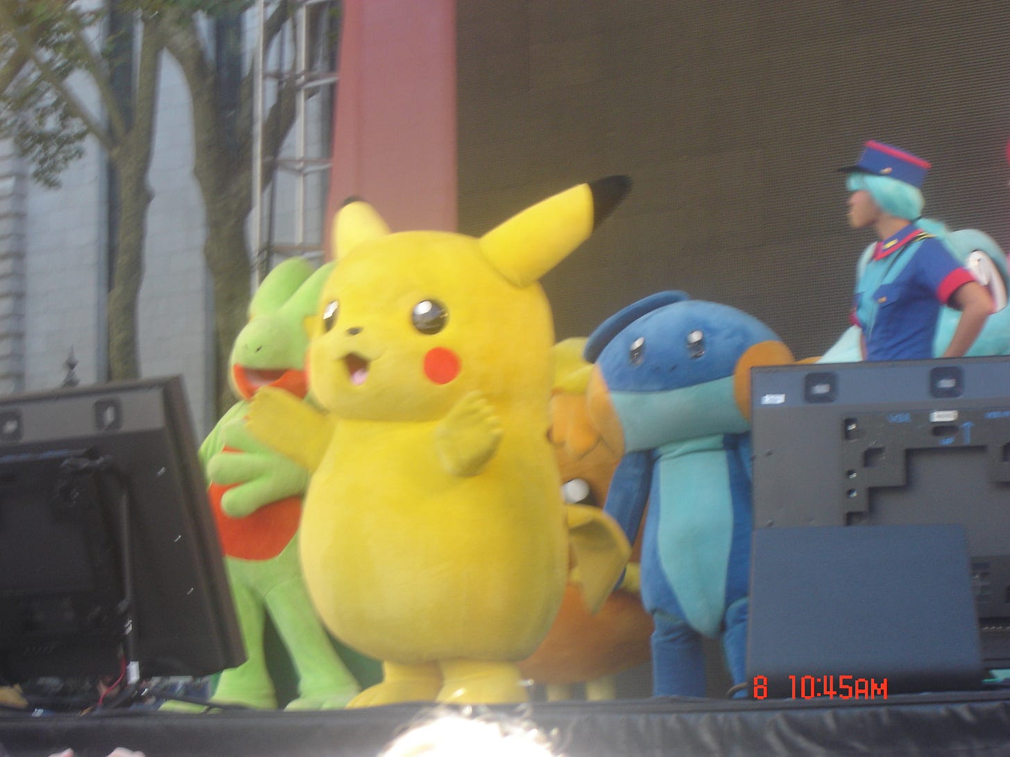 Treecko, Pikachu, Mudkip, and Totodile take to the stage, with what appears to be an Officer Jenny cosplayer Treecko, Pikachu, Mudkip, and Totodile take to the stage, with what appears to be an Officer Jenny cosplayer