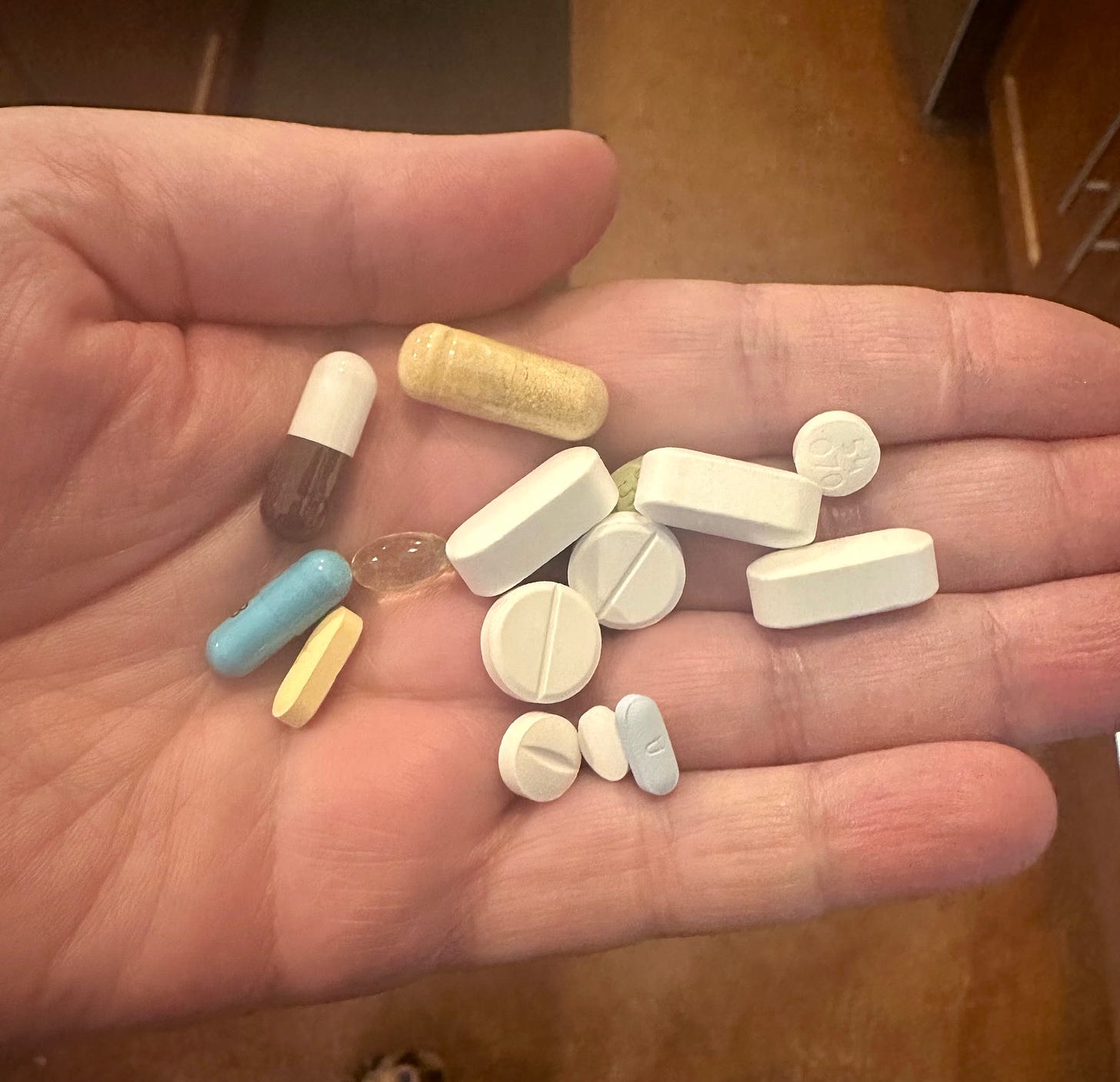 hand holding a pile of pills