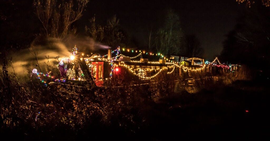barge decorated with colourful lights at night time