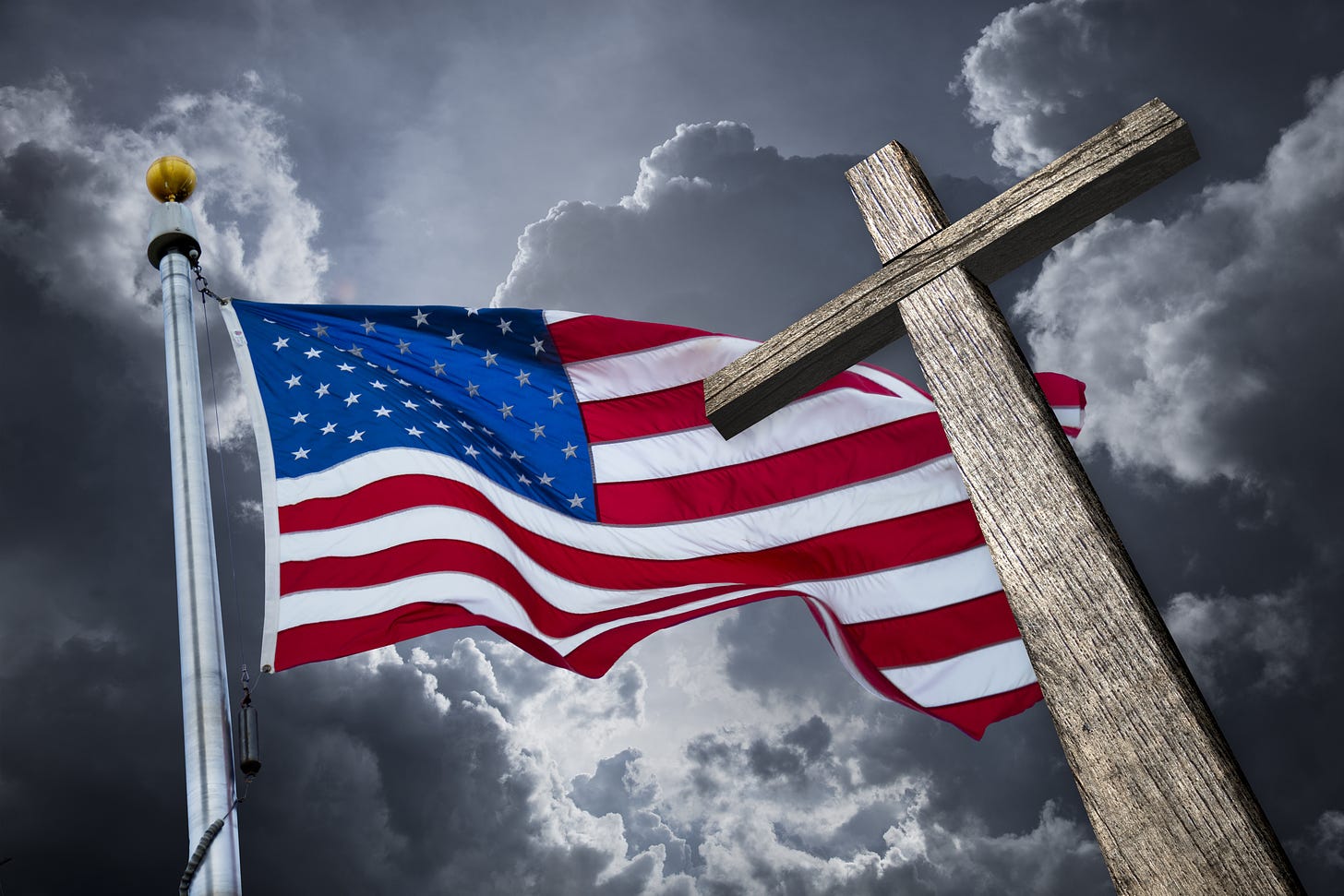 a Christian cross in front of an American flag against a dark sky