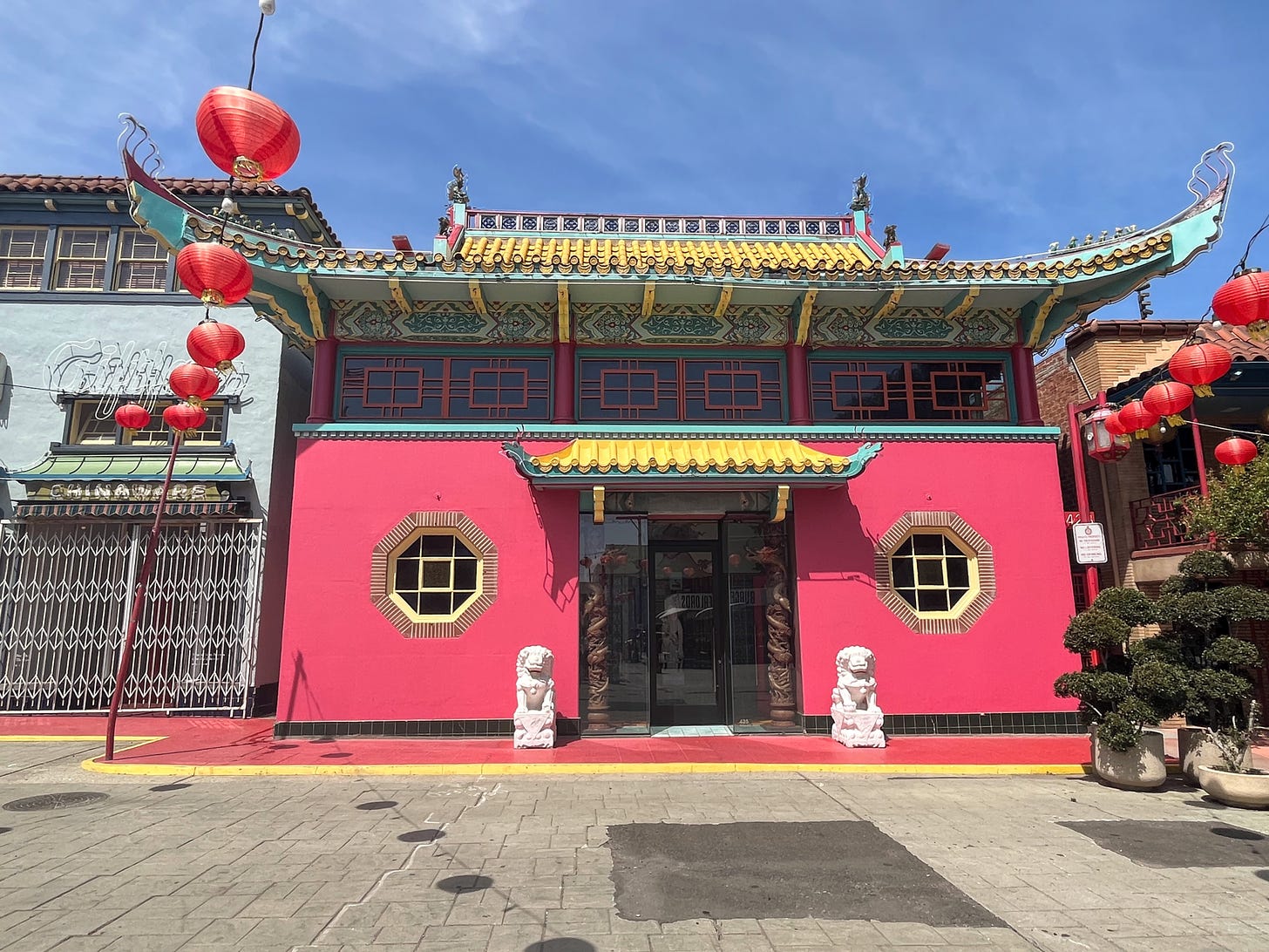 View of pink single story building decorated in the vintage Chinese style.
