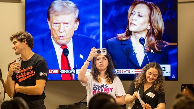 Crowd watching Trump and Harris debate. | José Luis Villegas/TNS/Newscom