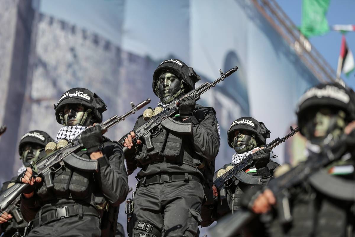Members of Izz ad-Din al Qassam Brigades, the armed wing of Palestinian group Hamas, parade on the Hamas' 35th anniversary at Al-Qatiba Square in Gaza City, Gaza on December 14, 2022. [Ali Jadallah - Anadolu Agency]