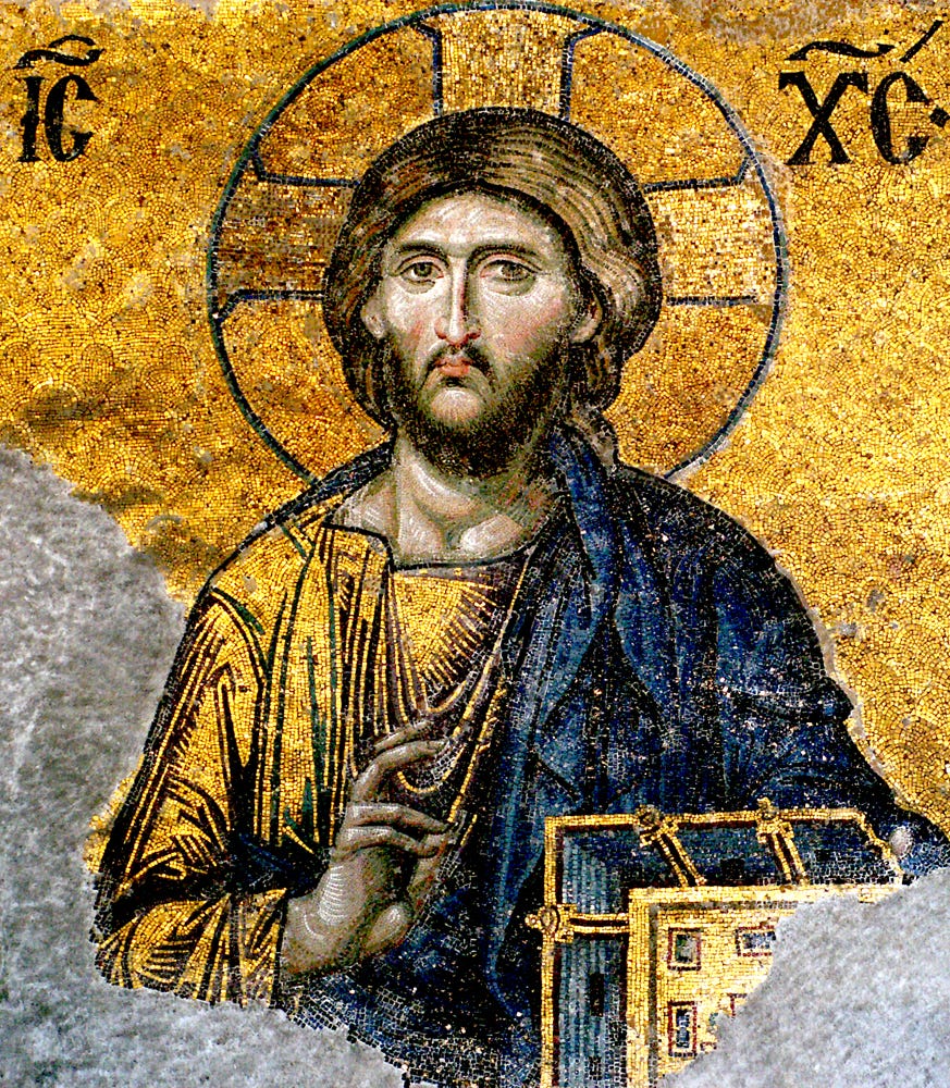 Mosaic of Jesus Christ with a golden halo, giving a blessing gesture, set against a gold background; part of the image is worn away at the lower left. Mosaic of Jesus Christ with a golden halo, giving a blessing gesture, set against a gold background; part of the image is worn away at the lower left.