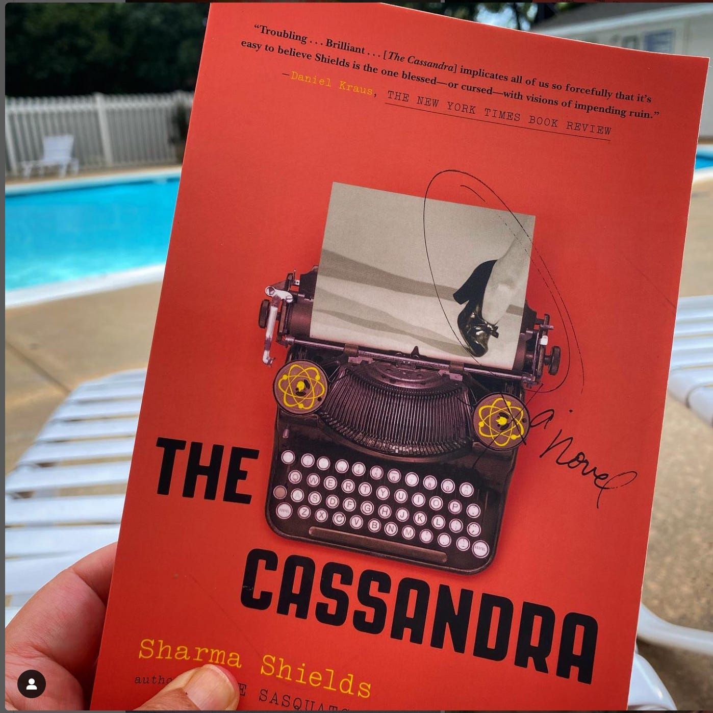 orange book with an old typewriter and nuclear symbols. Title: the Cassandra by Sharma Shields