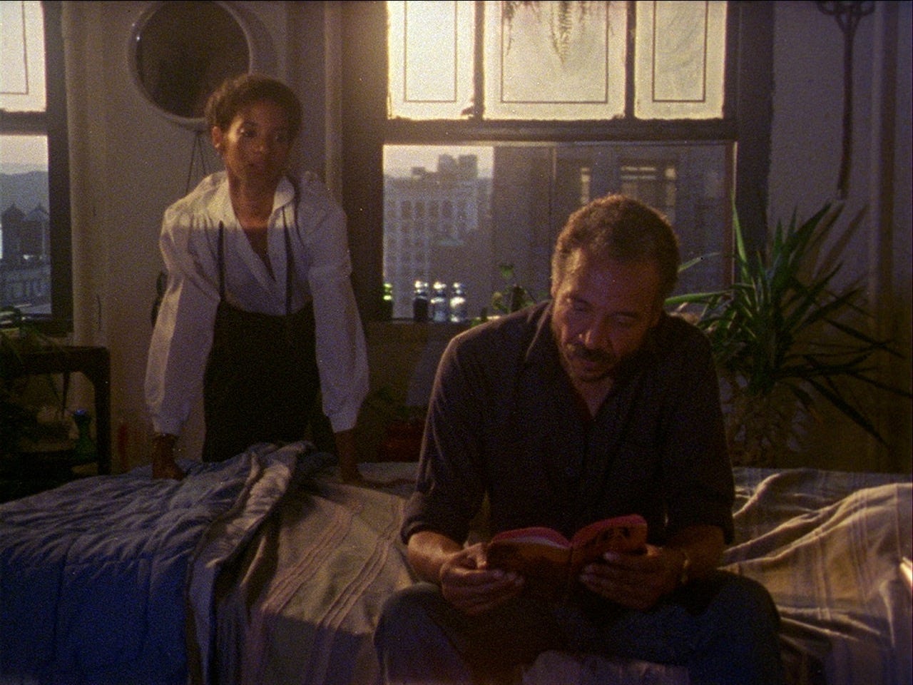 Seret Scott leans over the bed that Bill Gunn is seated on in Losing Ground (1982)