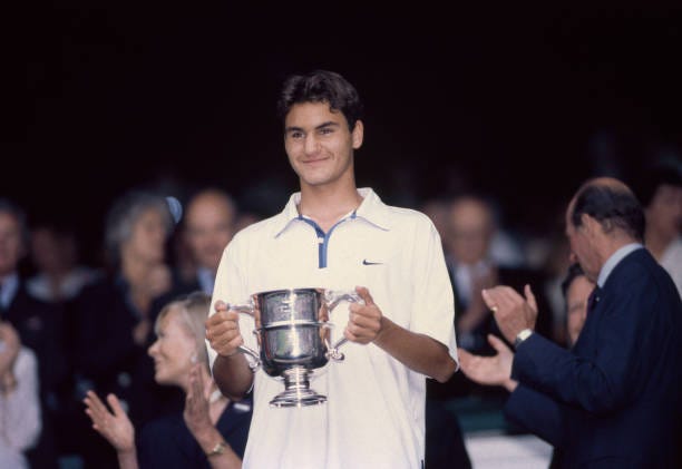 Roger Federer of Switzerland poses with the trophy after defeating Irakli Labadze of Georgia in the Boys' Singles Final of the Wimbledon Lawn Tennis...