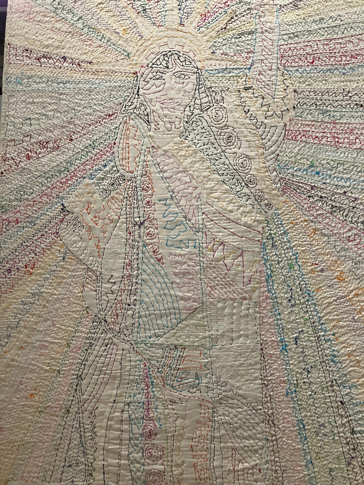 reverse side of quilt with stitching outlining statue of liberty figure