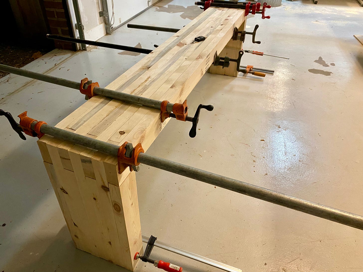 Wooden bench in clamps
