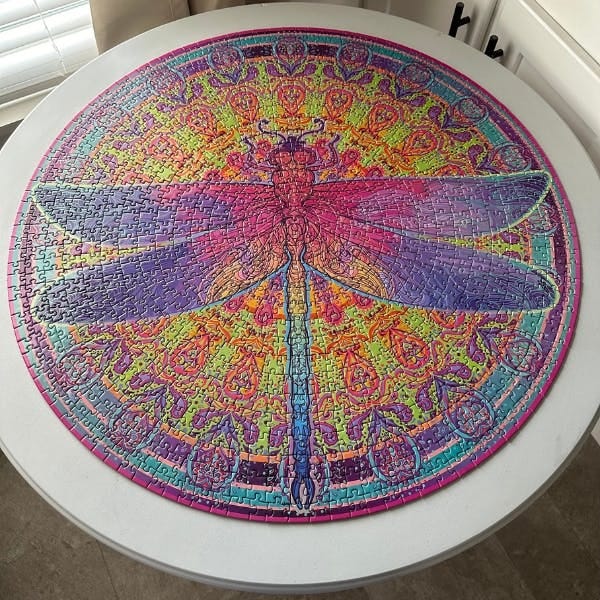 Zentangle dragonfly puzzle; it's round, 26.5 inches in diameter, and the color themes merge and blend and complement and generally make it gorgeous.
