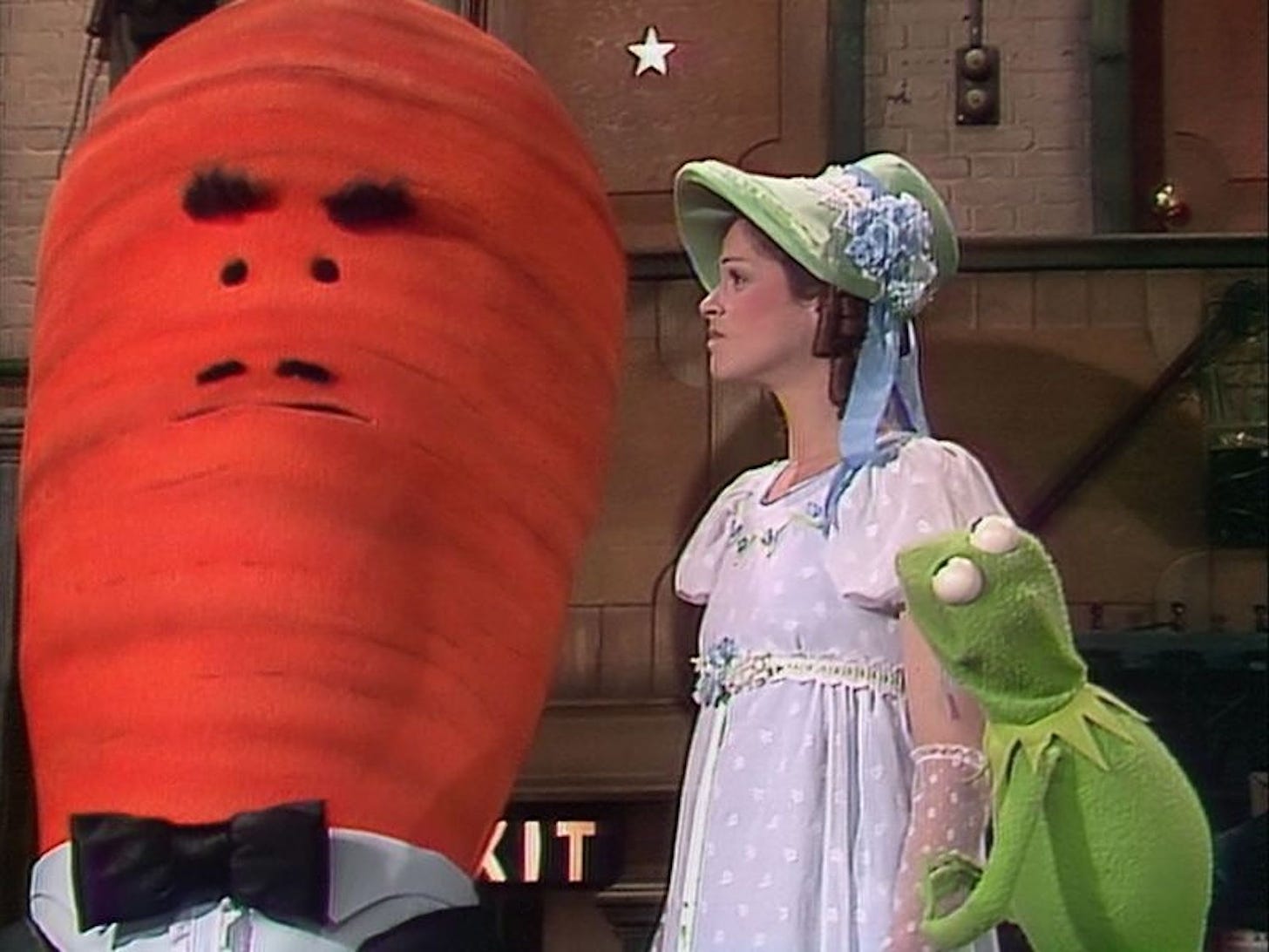 (l-r) A 7-foot-tall talking carrot in a suit, Gilda Radner, and Kermit the Frog on THE MUPPET SHOW.