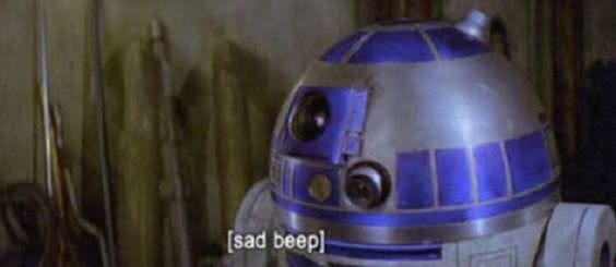Screenshot of a frame of Star Wars showing R2D2 with the closed caption "[sad beep]"